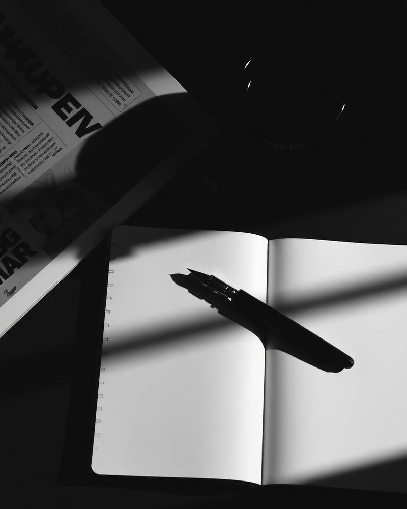 Editorial flatlay — notebook, pen, coffee